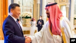 In this photo made available by Saudi Press Agency, SPA, Saudi Crown Prince and Prime Minister Mohammed bin Salman greets Chinese President Xi Jinping during the Gulf Cooperation Council (GCC) Summit, in Riyadh, Saudi Arabia, Dec. 9, 2022. 