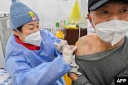 FILE - A man receives a Covid-19 coronavirus vaccine in Qingzhou, in China's eastern Shandong province on December 29, 2022. (Photo by AFP)
