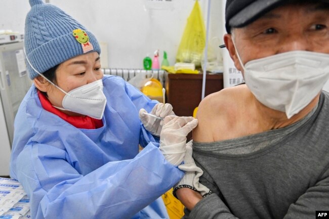 FILE - A man receives a Covid-19 coronavirus vaccine in Qingzhou, in China's eastern Shandong province on December 29, 2022. (Photo by AFP)