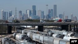 FILE - The Houston, Texas, skyline is seen from a railroad yard on March 6, 2019. 