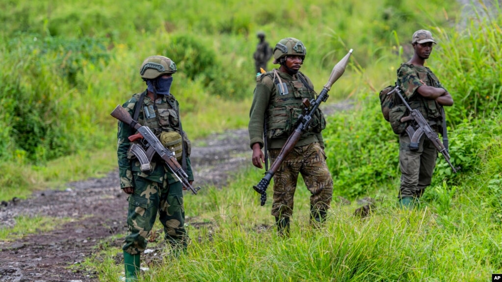 FILE - M23 rebels stand in the town of Kibumba, in the eastern of Democratic Republic of Congo, Dec. 23, 2022. Twenty-six defendants accused of belonging to the M23 rebel group are on trial in Kinshasa, with the prosecution on Monday calling for the death penalty for 25 of them.