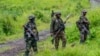 FILE - M23 rebels stand with theirs weapons in the town of Kibumba, in the eastern of Democratic Republic of Congo, Dec. 23, 2022.