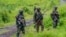 FILE - M23 rebels stand with theirs weapons in the town of Kibumba, in the eastern of Democratic Republic of Congo, Dec. 23, 2022.