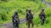 FILE - M23 rebels stand with their weapons in the town of Kibumba, in the eastern of Democratic Republic of Congo, Dec. 23, 2022.