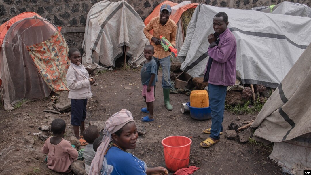 Families displaced by the M23 conflict crisis open Christmas gifts during an activity organized by the Un Jour Nouveau organisation in Kanyarushinya in the north of Goma city in the Democratic Republic of Congo, Dec. 24, 2022.