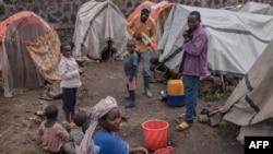 Families displaced by the M23 conflict crisis open Christmas gifts during an activity organized by the Un Jour Nouveau organisation in Kanyarushinya in the north of Goma city in the Democratic Republic of Congo, Dec. 24, 2022.