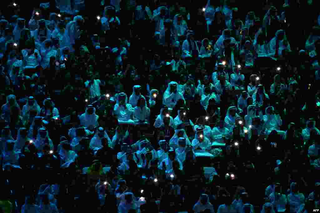 Supporters watch the opening ceremony of the Qatar 2022 World Cup Group A football match between Qatar and Ecuador.