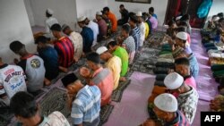 FILE - Rohingya refugees pray at a temporary shelter in Laweueng, Aceh province, Indonesia, on Dec. 29, 2022.