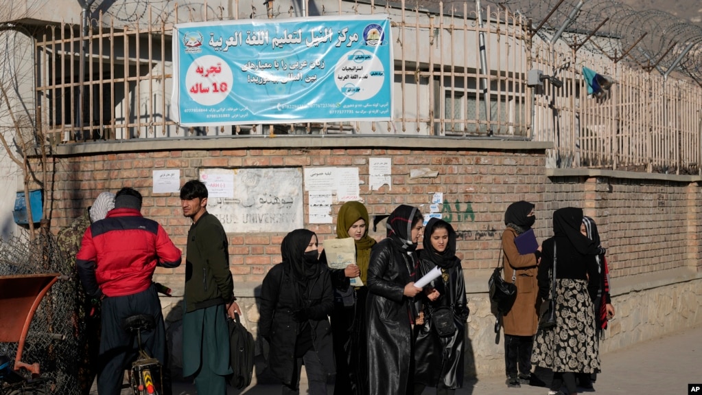 FILE - Afghan women stand outside Kabul University in Kabul, Afghanistan, on Dec. 21, 2022. The Taliban has increased restrictions on women in 2022 — including barring females from attending universities and banning women humanitarian workers — saying Islamic law mandates it.