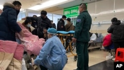 A sickened patient is moved onto a gurney at the emergency department of the Langfang No. 4 People's Hospital in Bazhou city in northern China's Hebei province on, Dec. 22, 2022. 