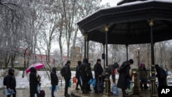 FILE - People wait in line to collect water, in Kyiv, Ukraine, Nov. 24, 2022.