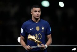 France's Kylian Mbappe holds the Golden Boot award for top goalscorer of the tournament after the World Cup final soccer match between Argentina and France at the Lusail Stadium in Lusail, Qatar, Dec. 18, 2022.