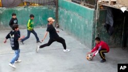 FILE - Migrant children play soccer inside a shelter in Tijuana, Mexico, Dec. 21, 2022.