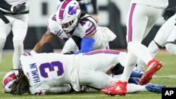 Buffalo Bills football player Damar Hamlin (3) lies on the ground after making a tackle on Cincinnati Bengals player Tee Higgins. After getting up from the play, Hamlin collapsed and was administered CPR on the field. (AP Photo/Joshua A. Bickel)