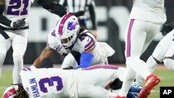 Buffalo Bills football player Damar Hamlin (3) lies on the ground after making a tackle on Cincinnati Bengals player Tee Higgins. After getting up from the play, Hamlin collapsed and was administered CPR on the field. (AP Photo/Joshua A. Bickel)