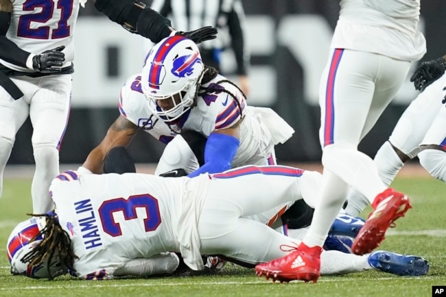 FILE - Buffalo Bills football player Damar Hamlin (3) lies on the ground after making a tackle on Cincinnati Bengals player Tee Higgins. After getting up from the play, Hamlin collapsed and was administered CPR on the field. (AP Photo/Joshua A. Bickel)