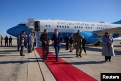 Ukraine's President Volodymyr Zelenskyy walks with Chief of Protocol of the United States Rufus Gifford as he arrives in Washington for talks with U.S. President Joe Biden and an address to a joint meeting of Congress, amid Russia's attack on Ukraine, in Washington, U.S., December 21, 2022. (Ukrainian Presidential Press Service/Handout via REUTERS)