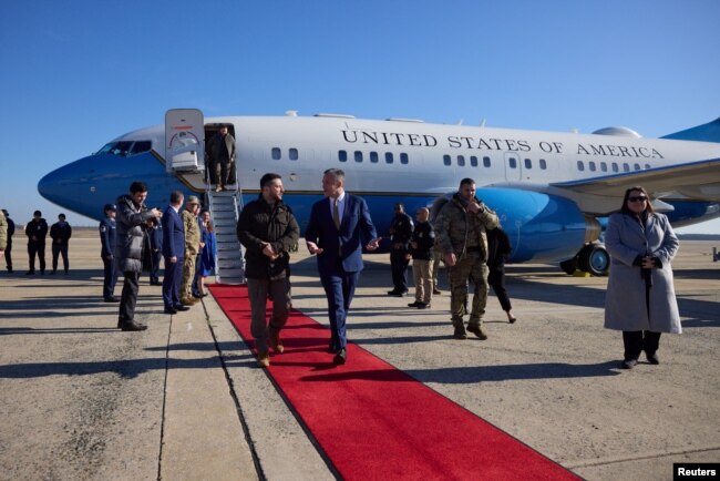 Ukraine's President Volodymyr Zelenskyy walks with Chief of Protocol of the United States Rufus Gifford as he arrives in Washington for talks with U.S. President Joe Biden and an address to a joint meeting of Congress, amid Russia's attack on Ukraine, in Washington, U.S., December 21, 2022. (Ukrainian Presidential Press Service/Handout via REUTERS)