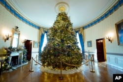 The White House Christmas Tree is on display in the Blue Room of the White House during a press preview of holiday decorations at the White House, Nov. 28, 2022, in Washington.