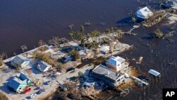 FILE - The bridge leading from Fort Myers to Pine Island, Fla., is seen heavily damaged in the aftermath of Hurricane Ian on Pine Island, Fla., Oct. 1, 2022.