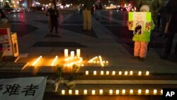 Candles lit in remembrance of Uyghurs who died in a building fire in China are seen as demonstrators gather at Freedom Plaza in Washington, Dec. 4, 2022, to protest in solidarity with the ongoing protests against the Chinese government's continued zero-COVID policies. 