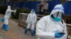 Epidemic prevention workers in protective suits walk outside a closed residential compound as the COVID-19 outbreak continues in Beijing, China November 18, 2022. 