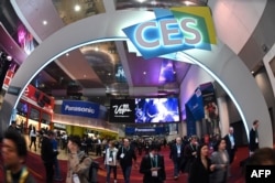FILE - Attendees walk through the 2020 Consumer Electronics Show (CES) in Las Vegas, Nevada, Jan. 10, 2020.