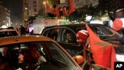 Morocco fans celebrate their team's victory against Spain in the World Cup round of 16 soccer match between Morocco and Spain, in Casablanca, Morocco, Dec. 6, 2022.