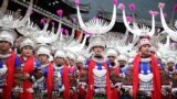 Women of the Miao ethnic minority, dressed in traditional costumes, taking part in the celebration of the Kuzang Festival in Leishan county, in China's southwestern Guizhou province, Nov. 19, 2022.