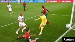 Ghana's captain André Ayew scores their opening goal in the Group H match against Portugal at the 2022 FIFA World Cup