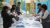 Election commission members count ballots at a polling station in Almaty, Kazakhstan, Nov. 20, 2022. 