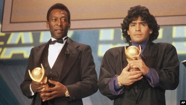 FILE - In this March 1987 photo, Pele, left, and Diego Maradona, hold trophies during an awards ceremony in Italy.