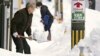 Residents shovel snow off a sidewalk in Kanazawa, Ishikawa prefecture, central Japan, on Dec. 24, 2022.