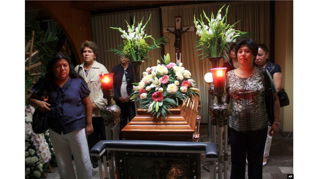 Kerabat, teman, dan jurnalis berdiri berjaga di samping peti mati berisi jasad jurnalis Regina Martinez yang terbunuh di Xalapa, Meksiko. (Foto AP/Felix Marquez)
