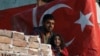 A Syrian migrant man and daughter stand in front of their shelter in Ulus district, the old part of Turkish capital Ankara, Turkey, Oct. 23, 2022. 