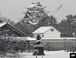 Nagoya castle is covered with snow on a winter day in Nagoya, Aichi prefecture, central Japan, on Dec. 24, 2022.