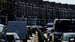 FILE - Cars wait in traffic on the A4, a main road in London, April 22, 2021. 
