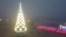 People walk past a Christmas tree decorated for Christmas and the New Year festivities in Mariupol, in Russian-controlled Donetsk region, eastern Ukraine, Dec. 24, 2022.