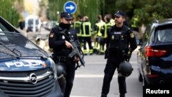 Police stand outside of the Ukrainian embassy after a blast inside the building injured one employee while handling a letter, in Madrid, Spain, Nov. 30, 2022.