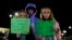 Willow Crawford, left, her sister Ava, right, and friend Kaylynn Vestre show support for Richneck Elementary School teacher Abby Zwerner during a vigil in Newport News, Va., Jan. 9, 2023. Zwerner was shot and wounded by a 6-year-old student Jan. 6.
