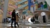 Shoppers walk through a reopened shopping mall after authorities started easing some of the COVID-19 restrictions in Beijing, Dec. 6, 2022.