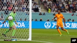 Denzel Dumfries scores the Netherlands' third goal during the World Cup round of 16 soccer match against the United States at Khalifa International Stadium in Doha, Qatar, Dec. 3, 2022. 