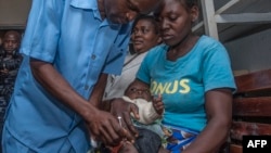 FILE - A baby is given a shot on the first day of the malaria vaccine implementation pilot program, at Mitundu Community hospital in Malawi's capital district of Lilongwe, April 23, 2019.