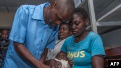 FILE - A baby is given a shot on the first day of the malaria vaccine implementation pilot program, at Mitundu Community hospital in Malawi's capital district of Lilongwe. Taken April 23, 2019.