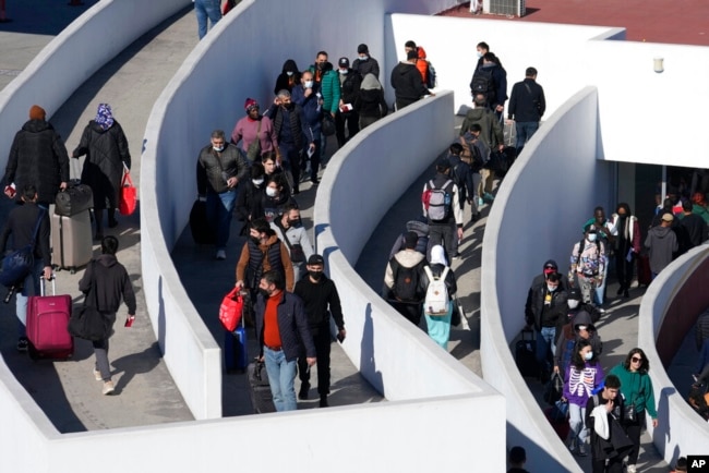 FILE - Migrants seeking asylum enter the U.S. in Tijuana, Mexico, Dec. 21, 2022. (AP Photo/Marcio Jose Sanchez)
