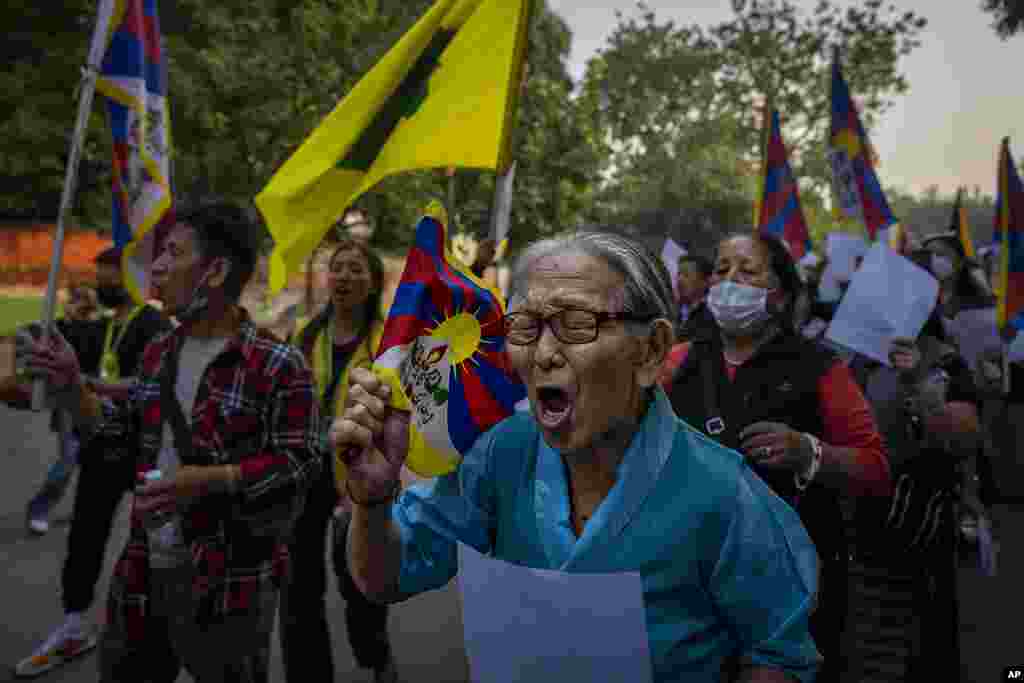 Exile Tibetan activists hold blank white papers symbolizing government censorship in China, while shouting anti-China slogans during a protest in New Delhi, India.