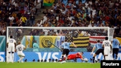 Uruguay's goalkeeper Sergio Rochet saves a penalty by Ghana's André Ayew in a Group H clash at the 2022 FIFA World Cup, Al Janoub Stadium, Qatar, December 2, 2022