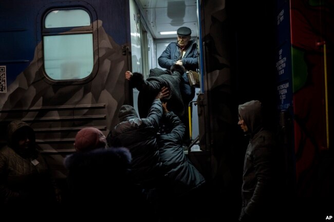 Ukrainians board the Kherson-Kyiv train at the Kherson railway station, southern Ukraine, Nov. 21, 2022.