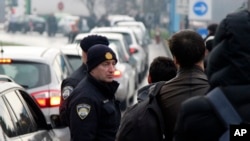 Croatian police officers secure a perimeter around the border crossing Maljevac, between Bosnia and Croatia, Dec. 27, 2022. Some 50 ethnic Chechens from Russia have reached Bosnia over the past week in search for a jumping-off point for the European Union.