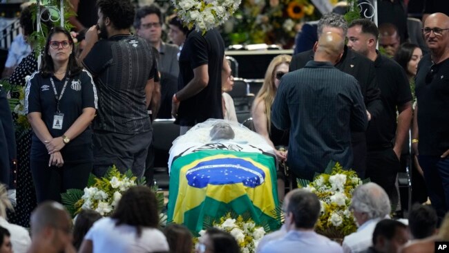 El ataúd con los restos del gran futbolista brasileño Pelé yace en estado durante su velatorio en la cancha del estadio Vila Belmiro en Santos, Brasil, el lunes 2 de enero de 2023. (Foto AP/Andre Penner)